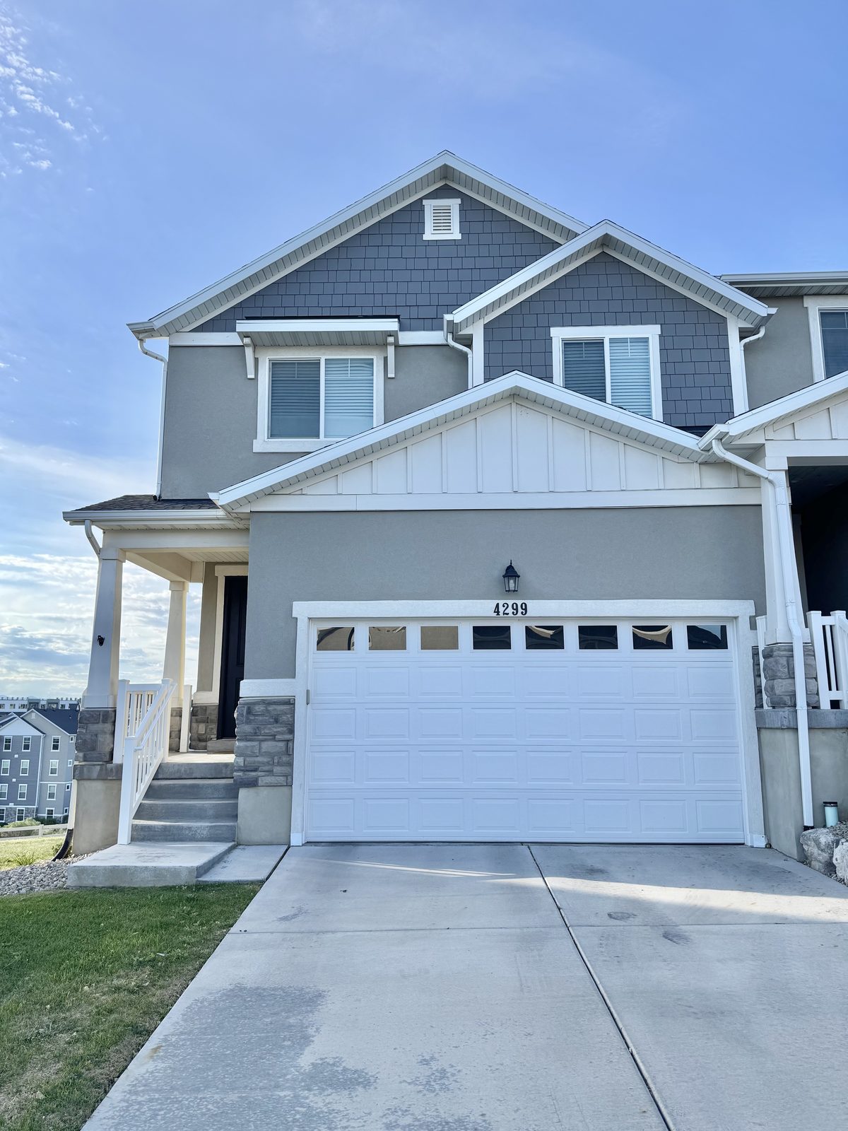 Two-story gray townhome with white garage door in Herriman, Utah